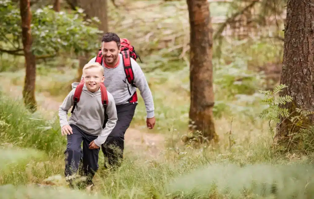 A father and son hiking in the woods