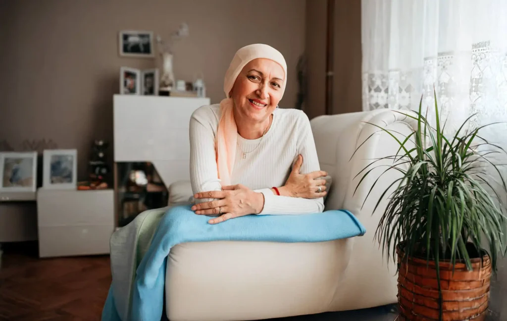 A cancer patient lies on the couch at home.